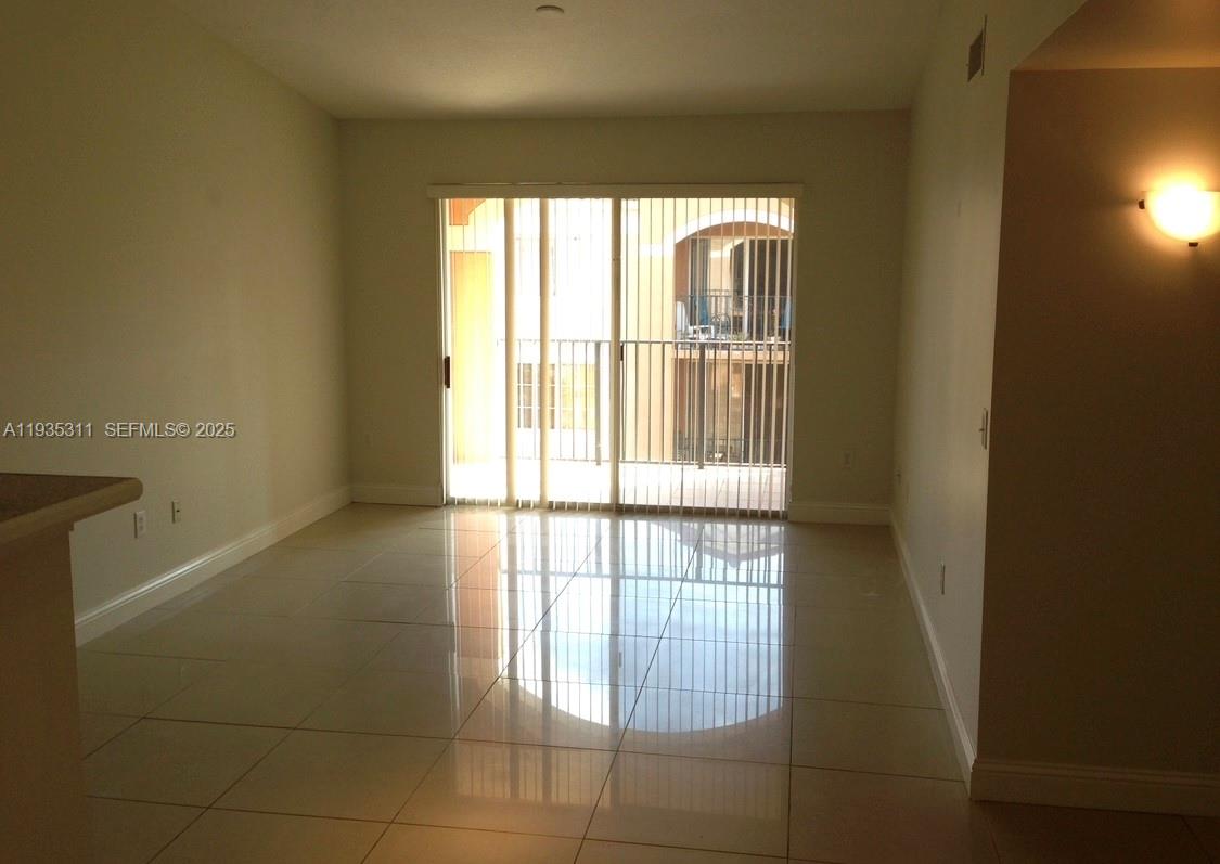6851 Southwest 44th Street, Unit 308 Miami, FL 33155 - Photo 7 of 13 a view of an empty room with a window