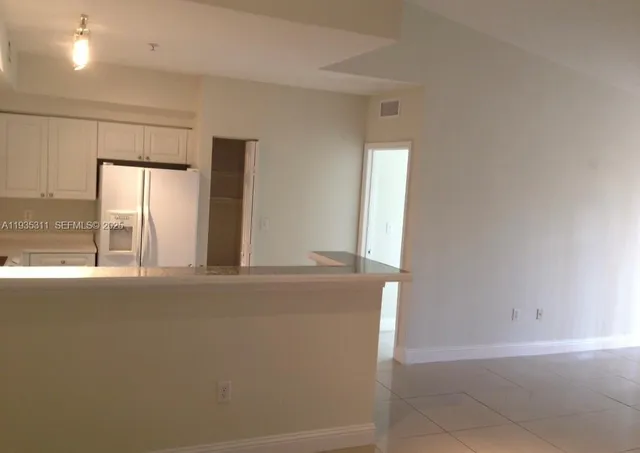a view of a kitchen with a sink and a window