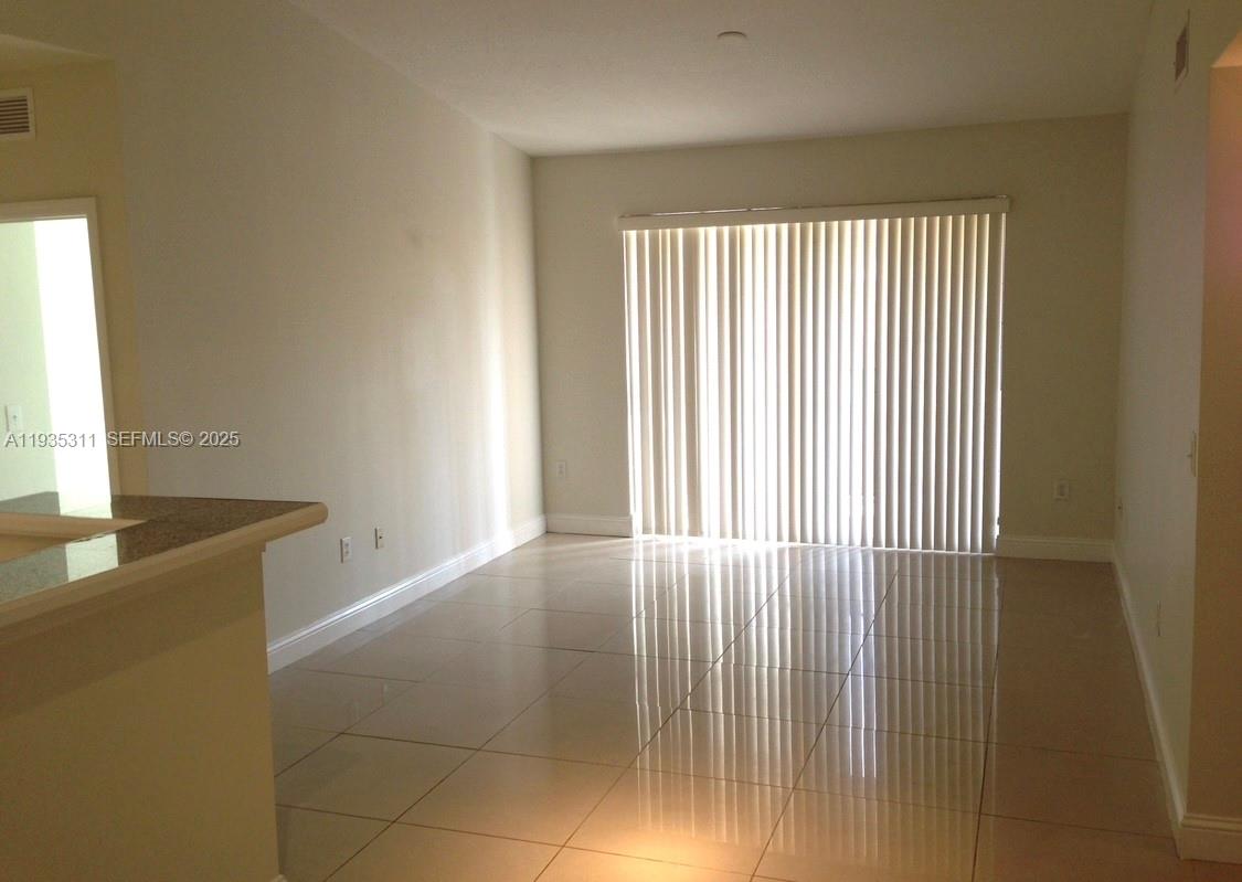 6851 Southwest 44th Street, Unit 308 Miami, FL 33155 - Photo 9 of 13 a view of an empty room with a window