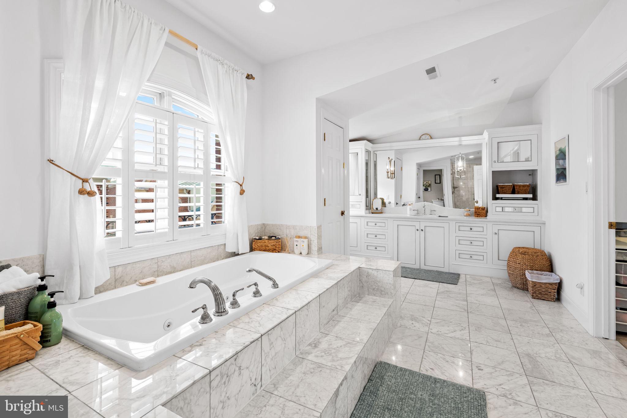 2331 Boston Street, Unit 1 Baltimore, MD 21224 - Photo 57 of 74 a spacious bathroom with a tub sink and mirror