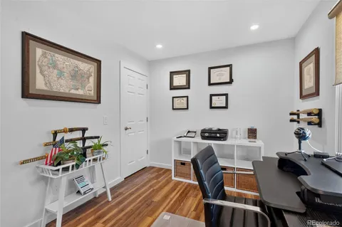 a view of a workspace with furniture and wooden floor