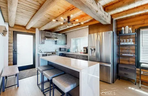 a large kitchen with a table and chairs