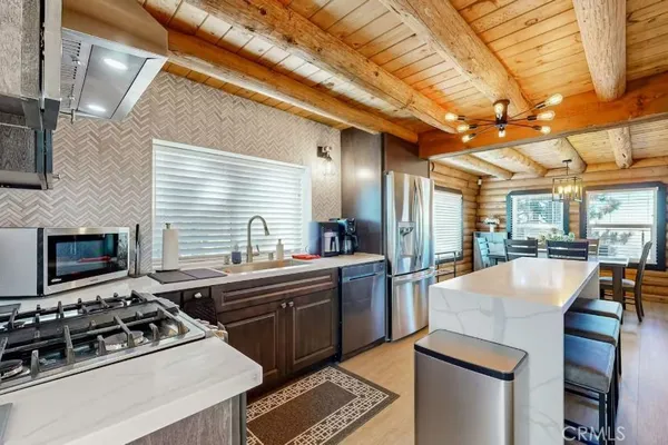 a kitchen with a stove a sink and a refrigerator