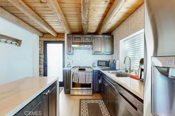 a kitchen with stainless steel appliances granite countertop a sink stove and cabinets