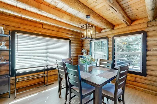 a dining room with furniture and wooden floor