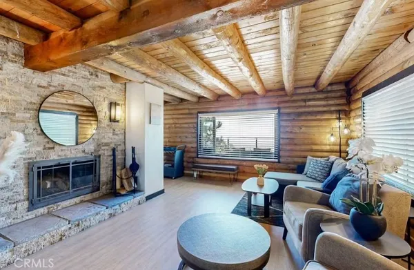 a living room with furniture a fireplace and a table