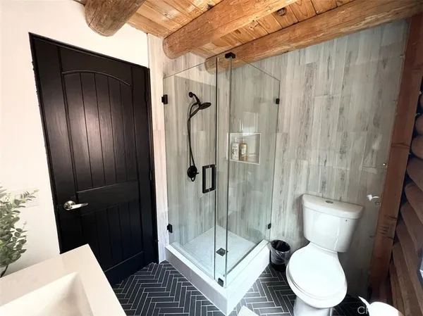 a bathroom with a toilet and a shower