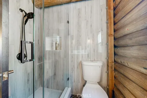 a bathroom with a toilet and a shower