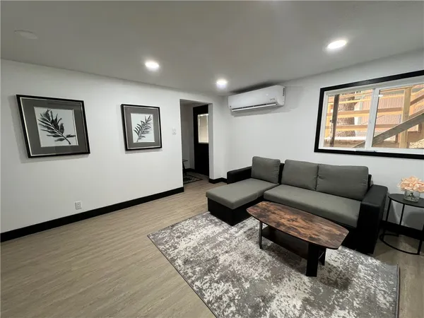 a view of a livingroom with furniture and wooden floor