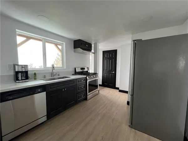 a kitchen with stainless steel appliances granite countertop a stove and a refrigerator