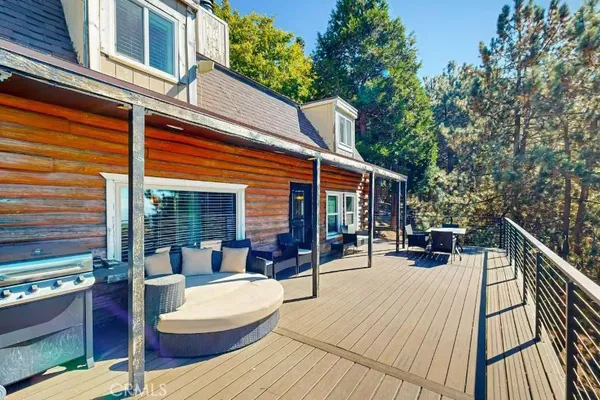 a view of a patio with couches table and chairs and potted plants