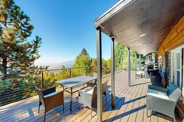 a view of a patio with couches table and chairs and potted plants