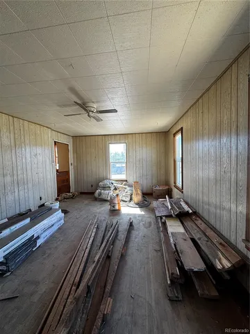 a spacious bedroom with a bed and a large window