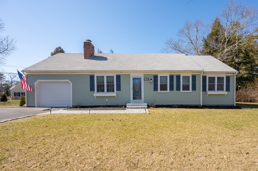 19 Huckins Neck Road Centerville, MA 02632 - Photo 1 of 42 a front view of house with yard and trees in the background