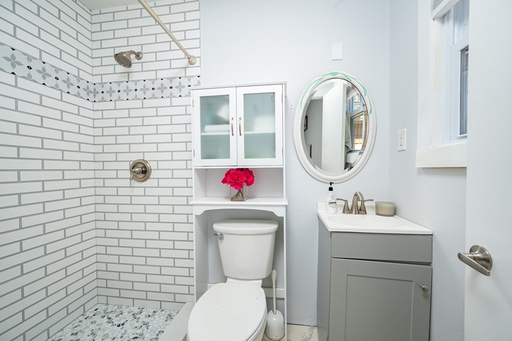 19 Huckins Neck Road Centerville, MA 02632 - Photo 19 of 42 a bathroom with a toilet sink vanity granite and mirror