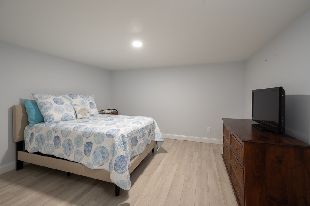 19 Huckins Neck Road Centerville, MA 02632 - Photo 24 of 42 a bedroom with a bed and a desk