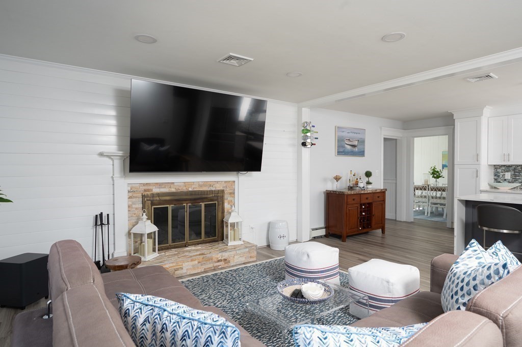 19 Huckins Neck Road Centerville, MA 02632 - Photo 6 of 42 a living room with furniture a fireplace and a flat screen tv