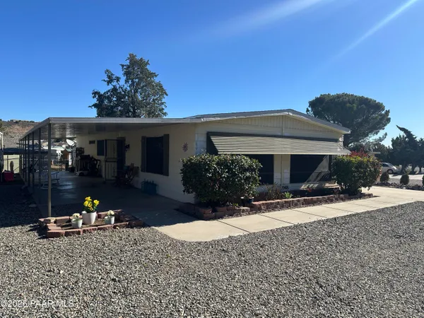 a view of a house with backyard and sitting area