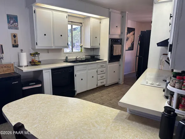 a kitchen with stainless steel appliances sink stove refrigerator and stove