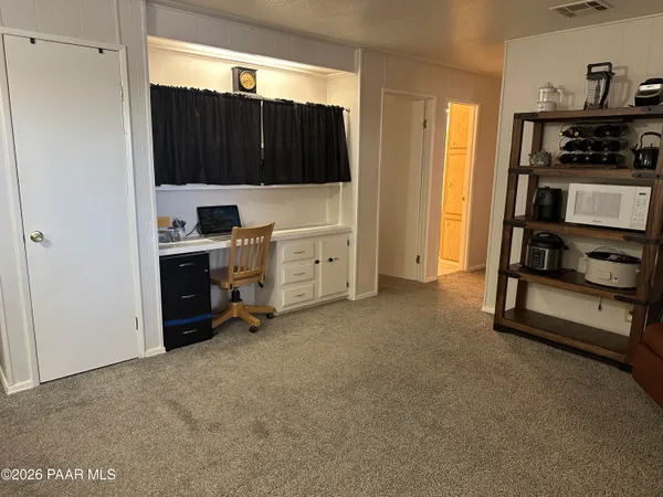 a view of kitchen with refrigerator and cabinets