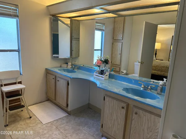 a bathroom with a double vanity sink and a mirror