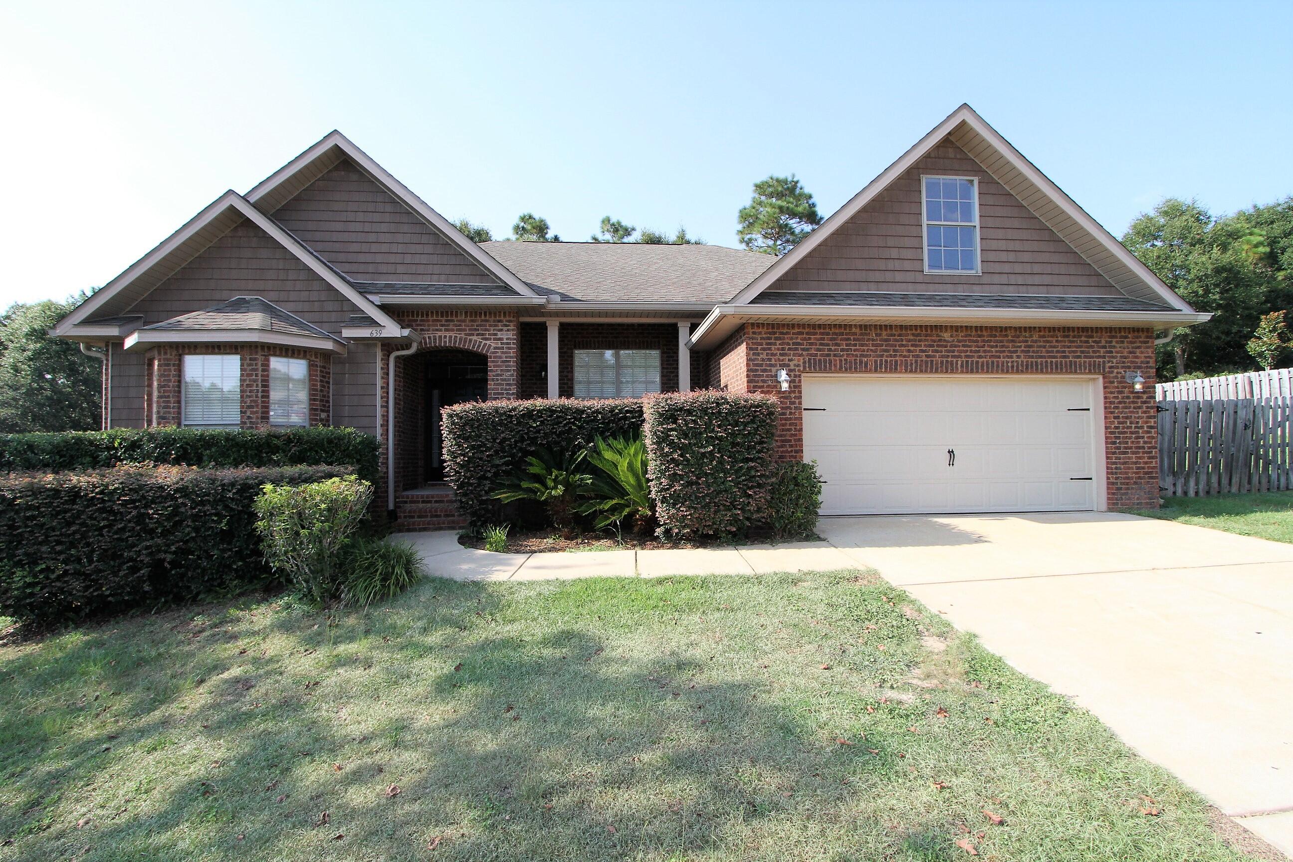 639 Red Fern Road Crestview, FL 32536 - Photo 1 of 24 a front view of a house with a yard and garage