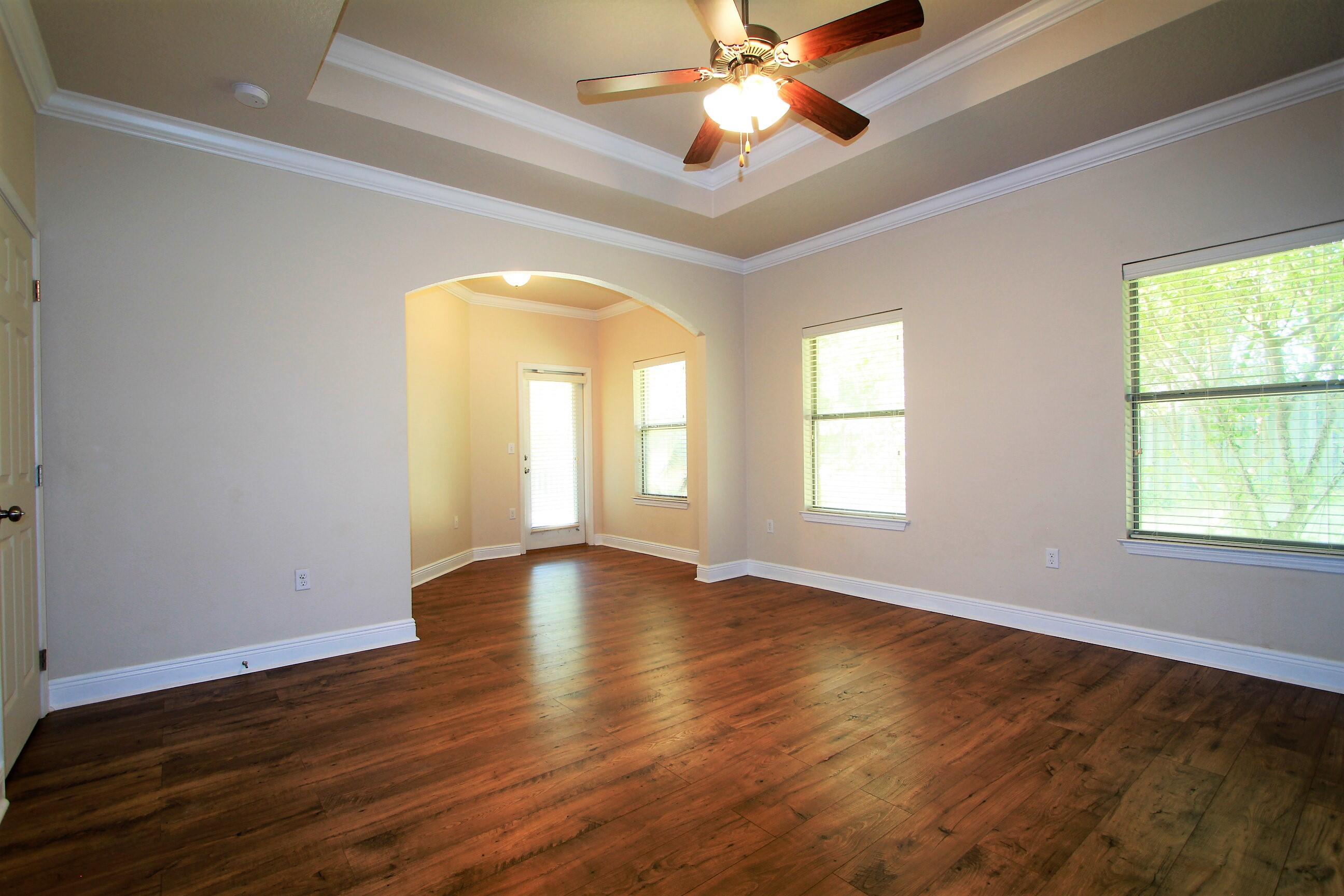 639 Red Fern Road Crestview, FL 32536 - Photo 13 of 24 a view of an empty room with wooden floor and a window