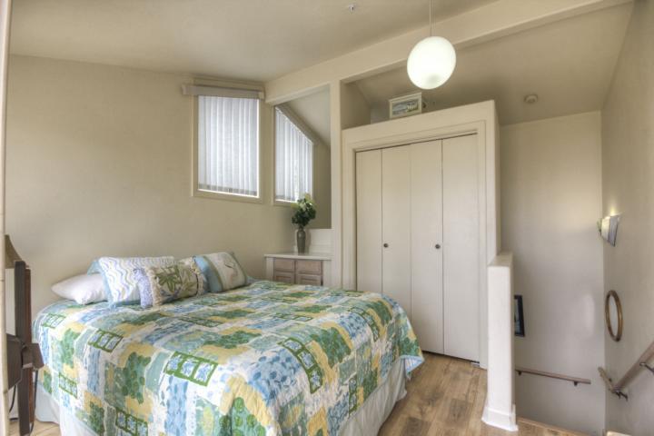 5005 Cliff Drive, Unit 2 Capitola, CA 95010 - Photo 12 of 21 a bedroom with a bed and a window