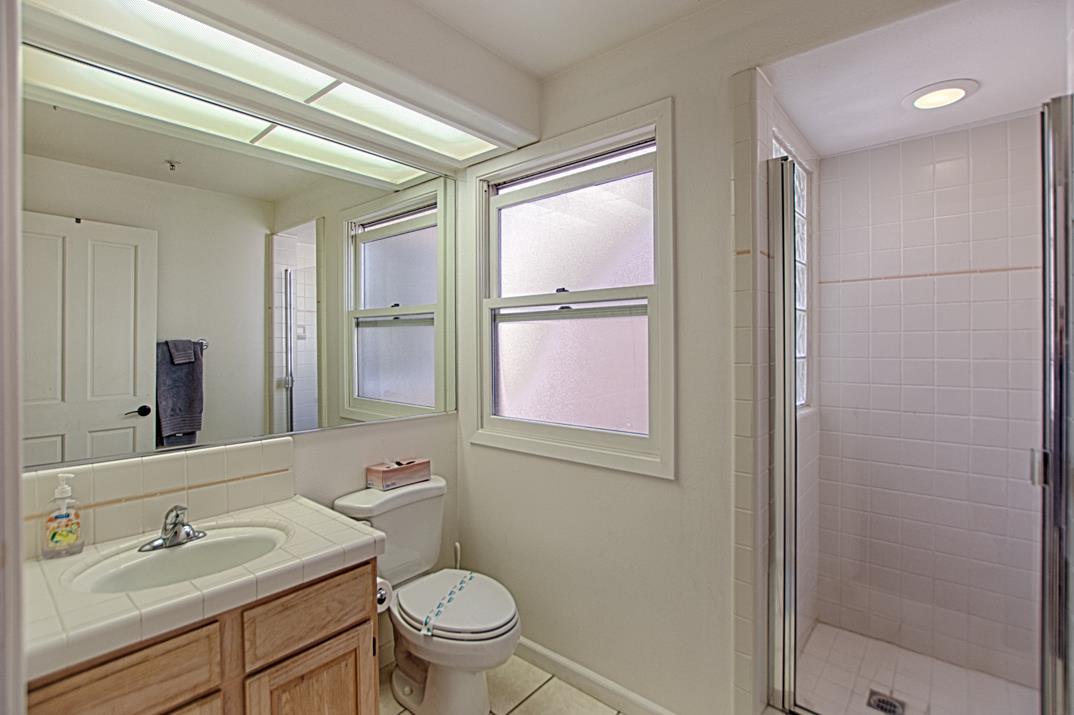 5005 Cliff Drive, Unit 2 Capitola, CA 95010 - Photo 13 of 21 a bathroom with a granite countertop sink toilet and shower