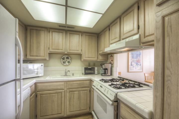 5005 Cliff Drive, Unit 2 Capitola, CA 95010 - Photo 9 of 21 a kitchen with stainless steel appliances granite countertop a sink stove oven and cabinets