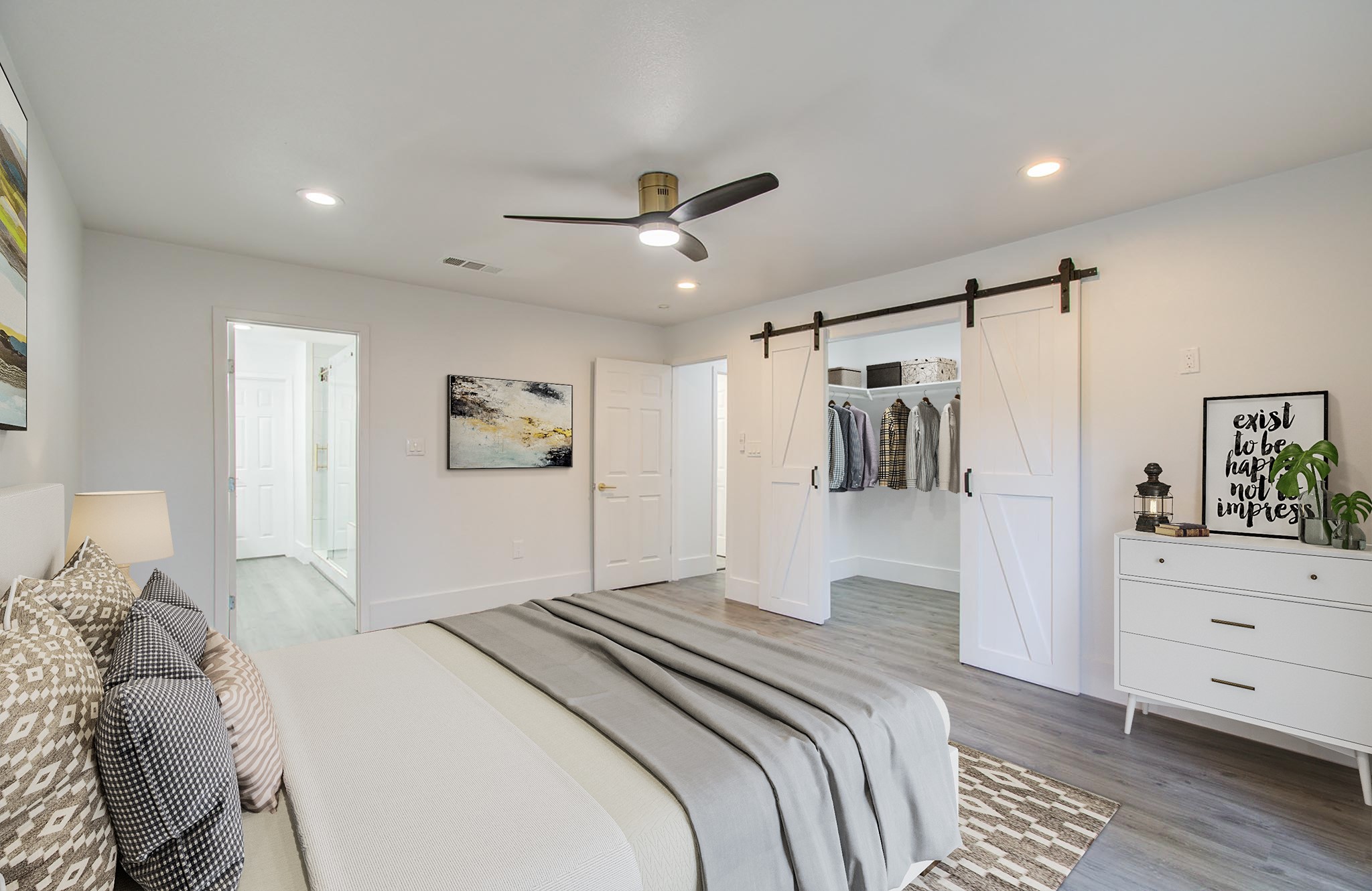 556 Brandon Road Conroe, TX 77302 - Photo 20 of 28 a bedroom with a large bed and a chandelier