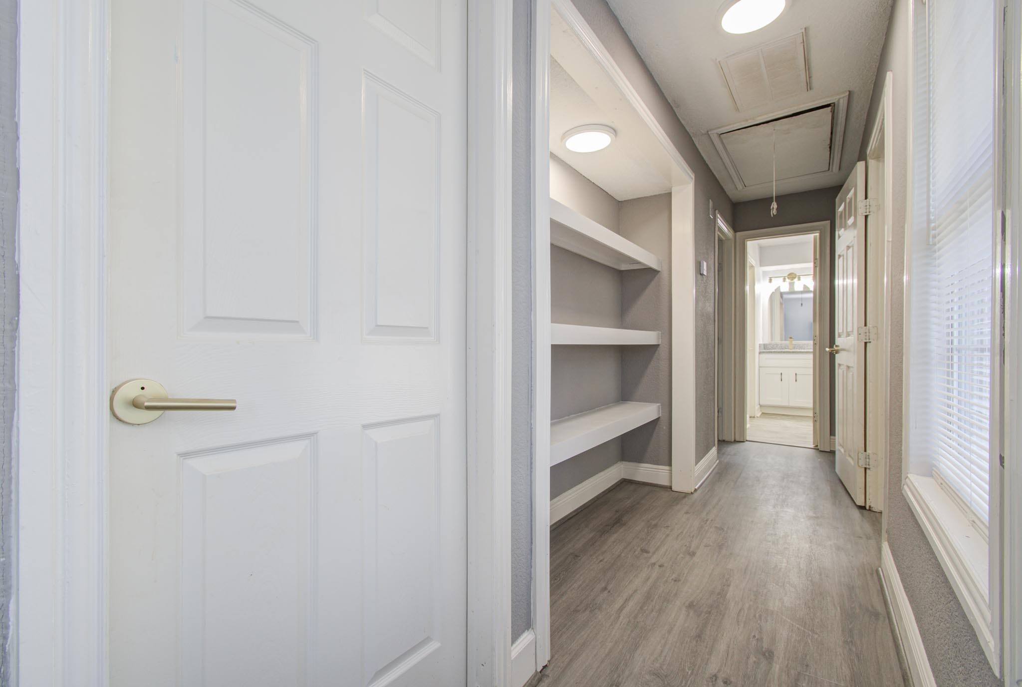 556 Brandon Road Conroe, TX 77302 - Photo 23 of 28 a view of a hallway with wooden floor and closet