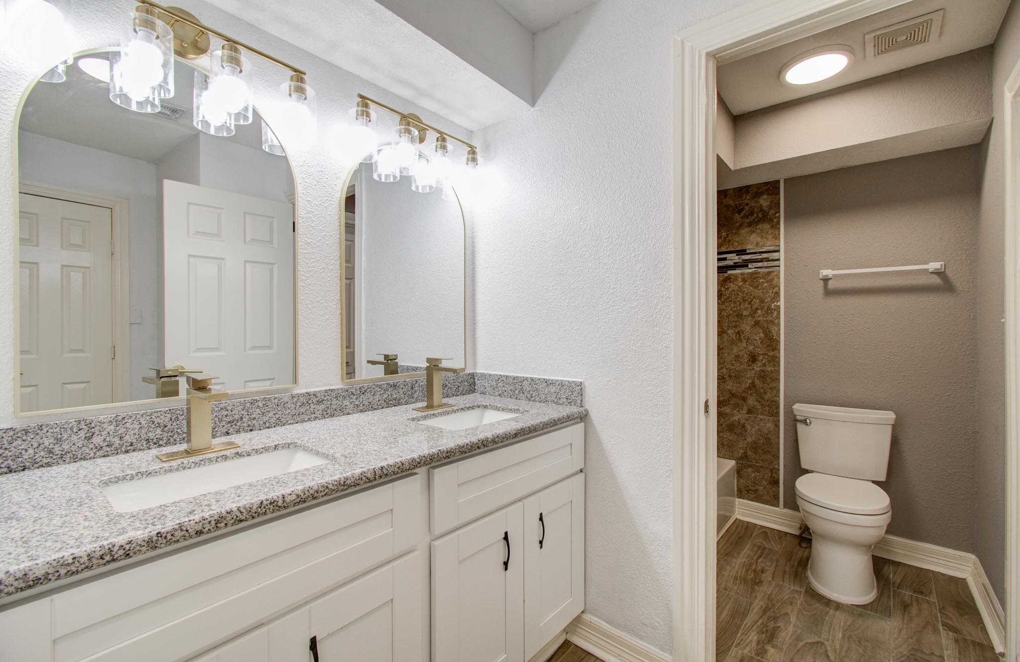 556 Brandon Road Conroe, TX 77302 - Photo 24 of 28 a bathroom with a granite countertop sink and a mirror