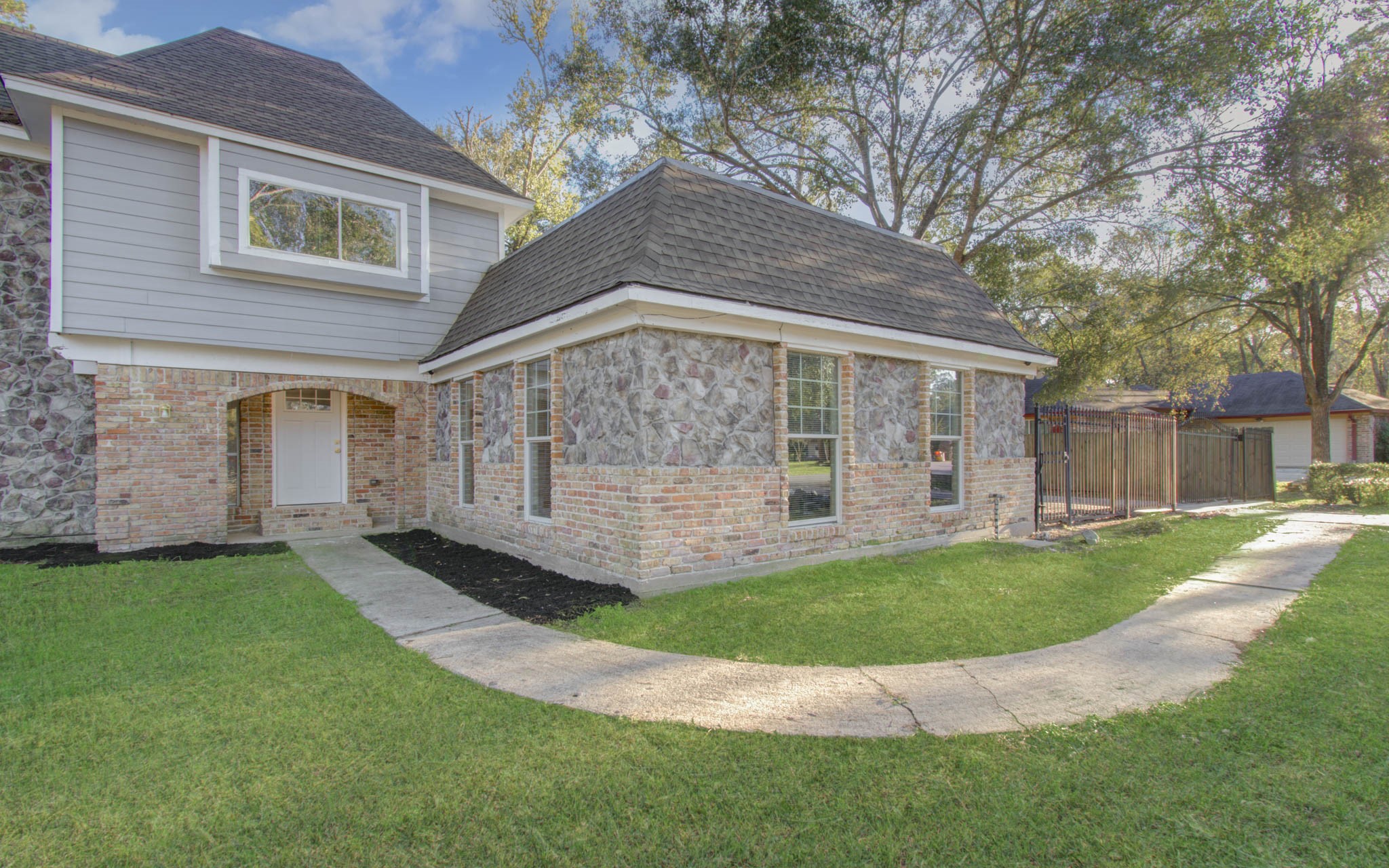 556 Brandon Road Conroe, TX 77302 - Photo 3 of 28 a view of a house with a yard and sitting area