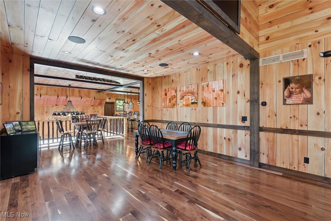 290 Townline Road Aurora, OH 44202 - Photo 13 of 50 Dining area with wood-type flooring, recessed lighting, wooden walls, and wooden ceiling