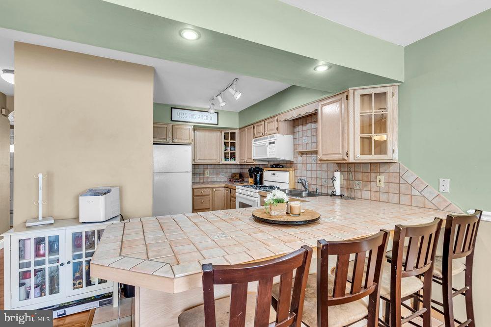1964 East Oak Road, Unit K4 Vineland, NJ 08361 - Photo 13 of 25 a kitchen with a dining table chairs and kitchen view