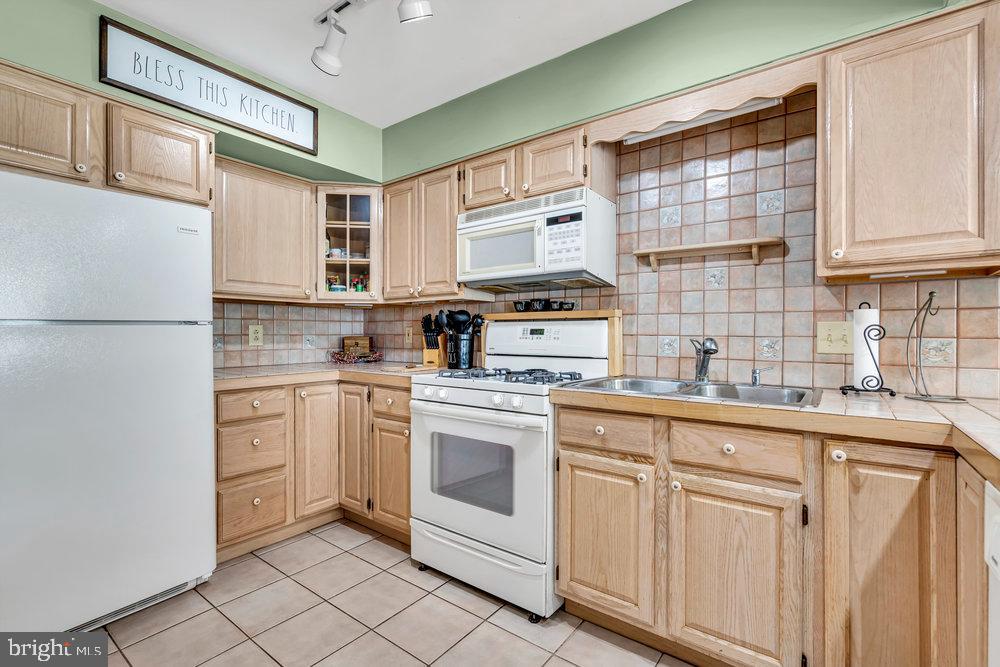 1964 East Oak Road, Unit K4 Vineland, NJ 08361 - Photo 14 of 25 a kitchen with cabinets appliances a sink and a window