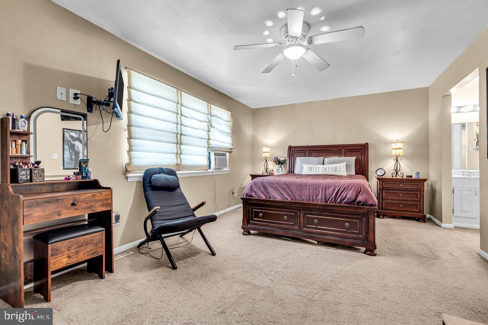 1964 East Oak Road, Unit K4 Vineland, NJ 08361 - Photo 19 of 25 a bedroom with a bed and a chandelier
