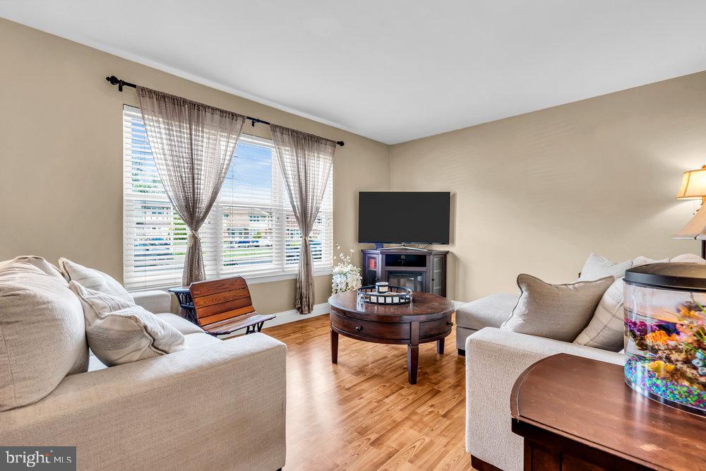 1964 East Oak Road, Unit K4 Vineland, NJ 08361 - Photo 8 of 25 a living room with furniture a flat screen tv and a large window