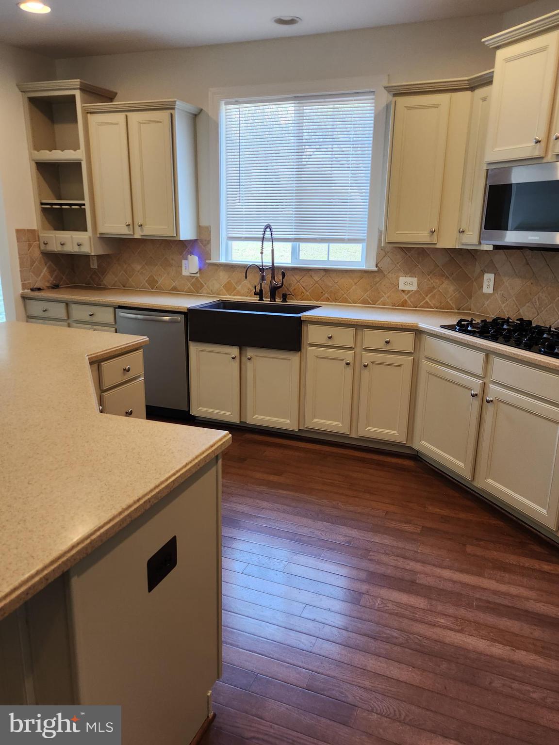 15117 Montanus Drive Culpeper, VA 22701 - Photo 11 of 27 a kitchen with stainless steel appliances granite countertop a sink a stove and cabinets