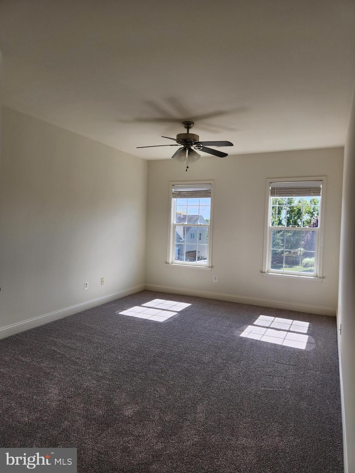 15117 Montanus Drive Culpeper, VA 22701 - Photo 19 of 27 an empty room with windows and chandelier fan