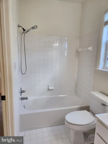 a bathroom with a toilet and a bath tub