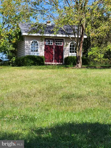 a front view of house with yard and trees