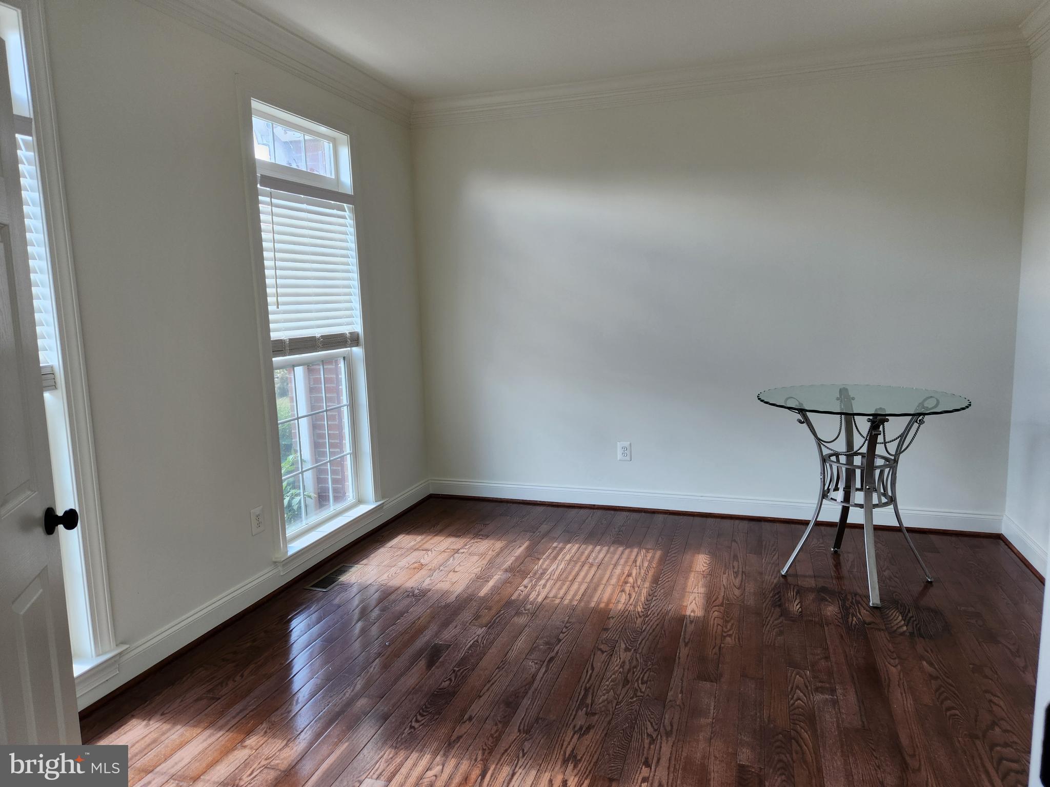 15117 Montanus Drive Culpeper, VA 22701 - Photo 8 of 27 an empty room with wooden floor chandelier and windows
