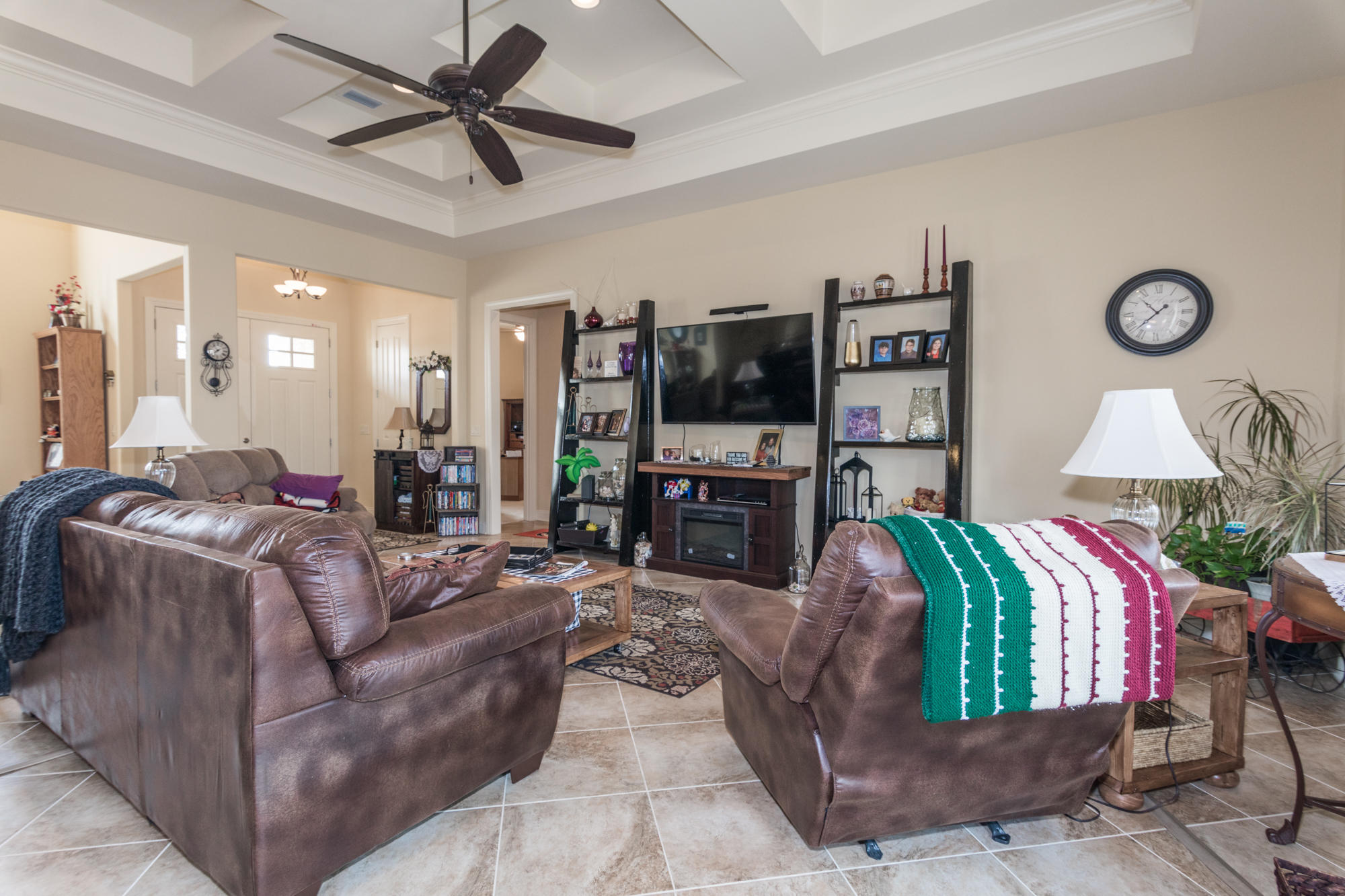 331 Brushed Dunes Circle Freeport, FL 32439 - Photo 5 of 60 a living room with furniture a ceiling fan and a flat screen tv