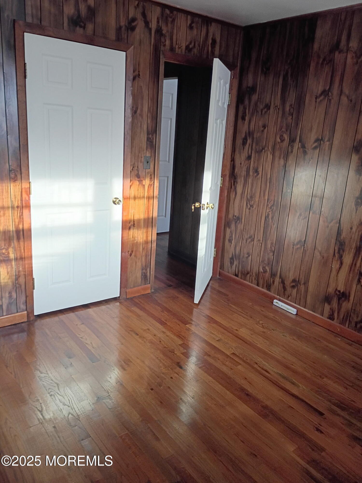 1595 Forge Pond Road Brick, NJ 08724 - Photo 16 of 35 an empty room with wooden floor and windows