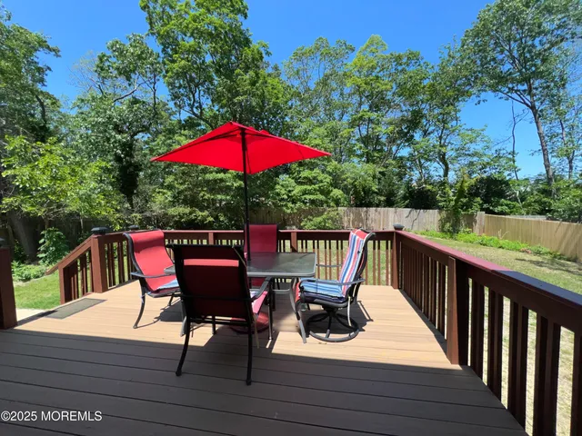 a view of balcony with wooden floor and outdoor seating
