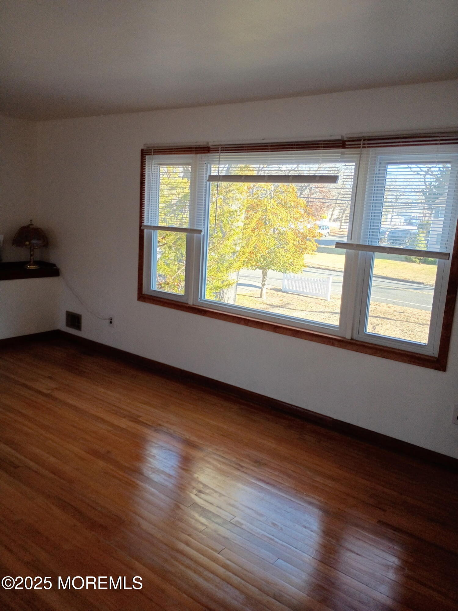 1595 Forge Pond Road Brick, NJ 08724 - Photo 6 of 35 a view of an empty room with wooden floor and a window