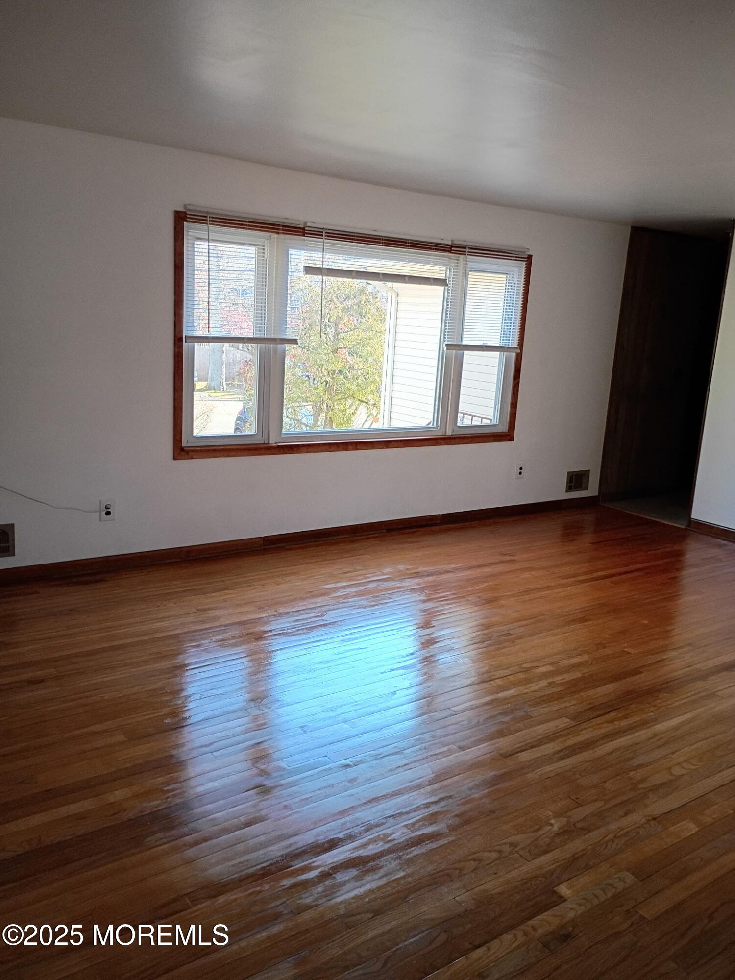 1595 Forge Pond Road Brick, NJ 08724 - Photo 7 of 35 an empty room with wooden floor and windows