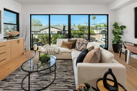 a living room with furniture and a floor to ceiling window